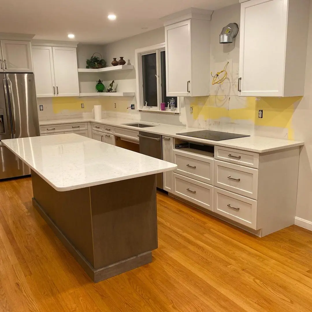 - 1 Modern kitchen with white marble countertops and island, hardwood flooring, and sleek cabinetry.