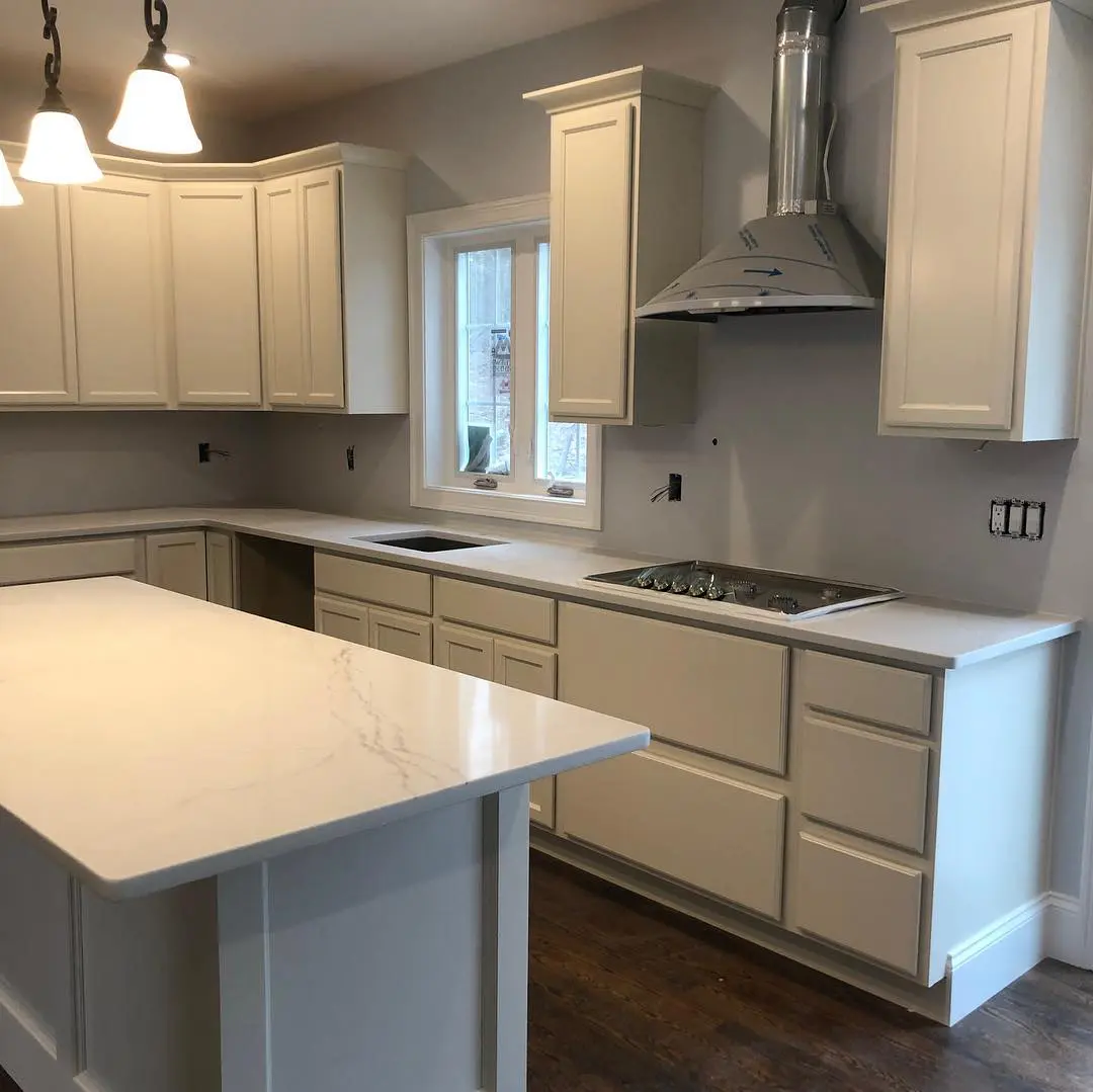 - 2 White kitchen with marble countertops and range hood