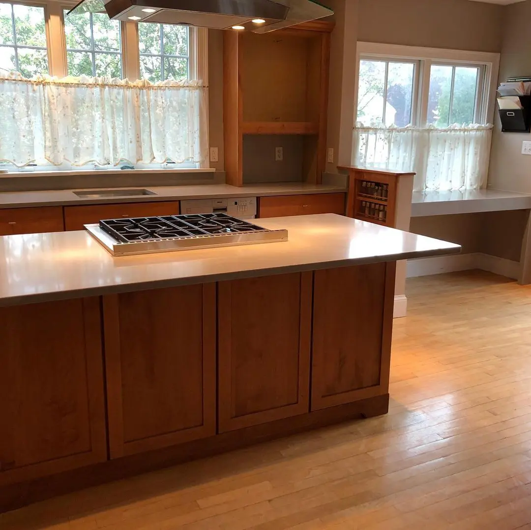 - 2 Granite kitchen island with natural wood cabinetry