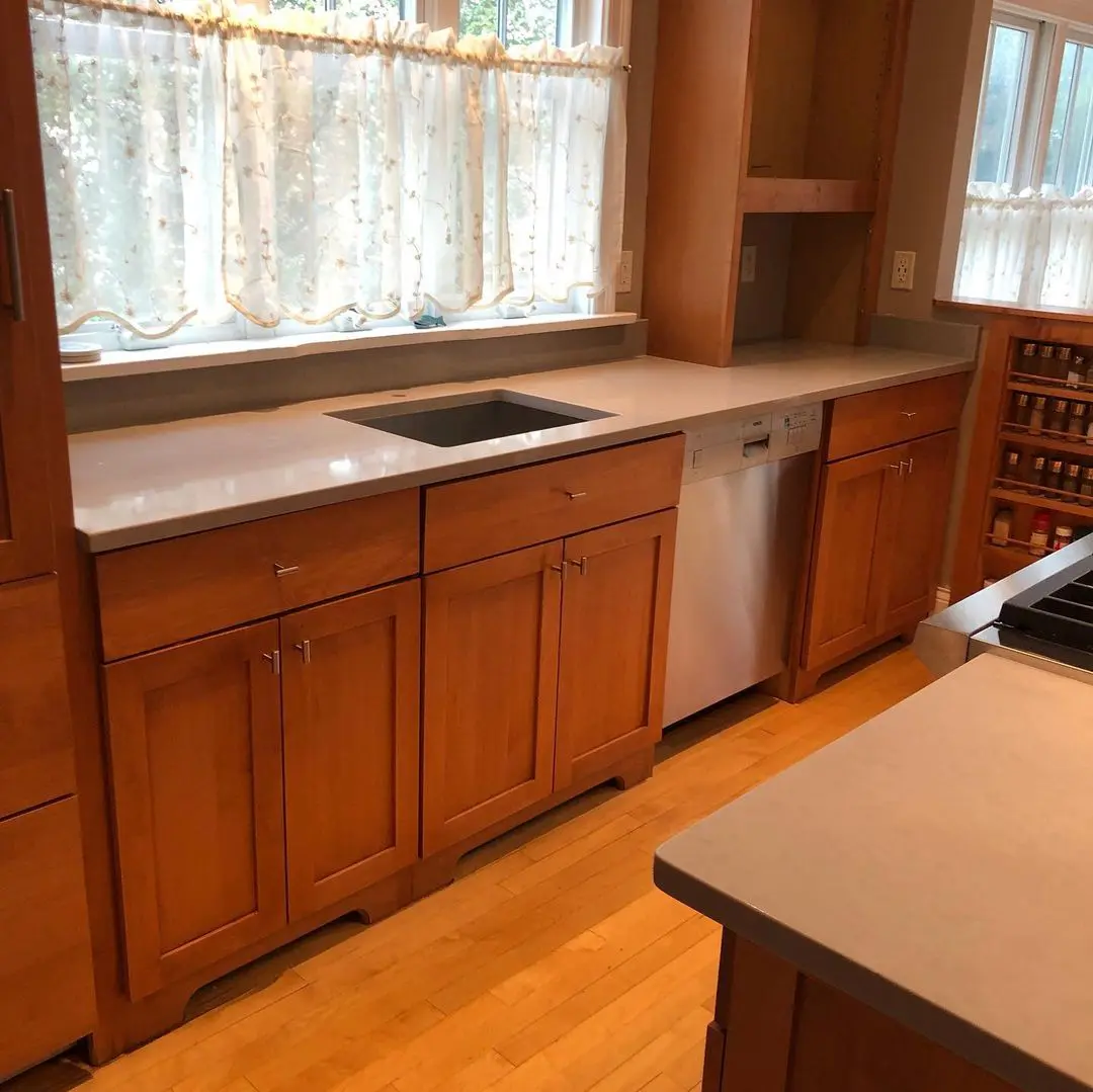 - 3 Granite countertop with wooden cabinets and window