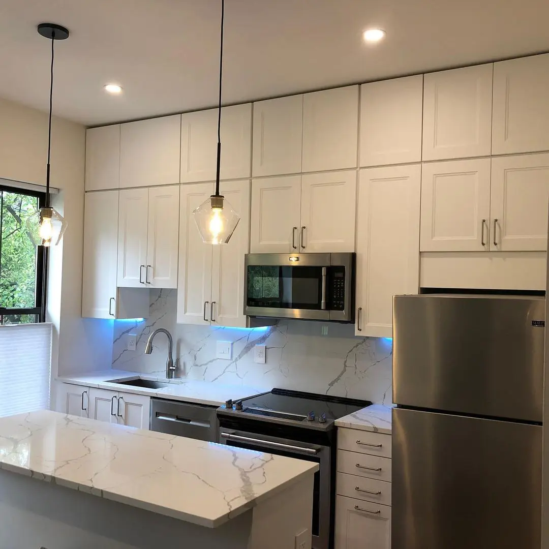 - 3 White kitchen with marble countertops and stainless appliances