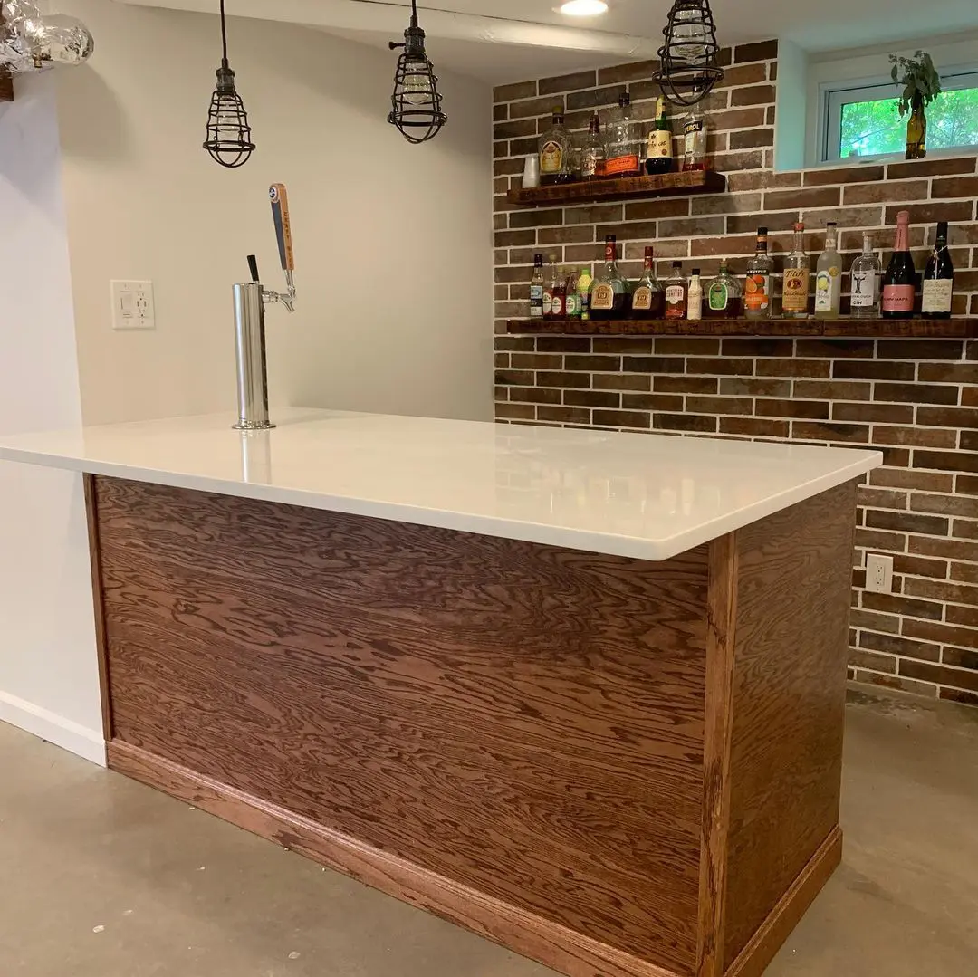 - 1 Kitchen island with white surface and wooden cabinetry in a contemporary home.