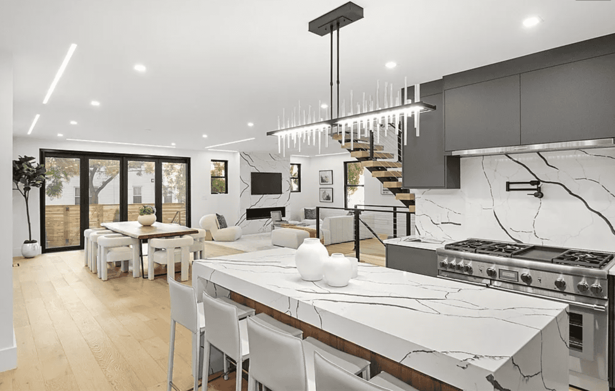 - 6 Four-inch miter waterfall island with full backsplash by Pablo Marble and Granite,LLC