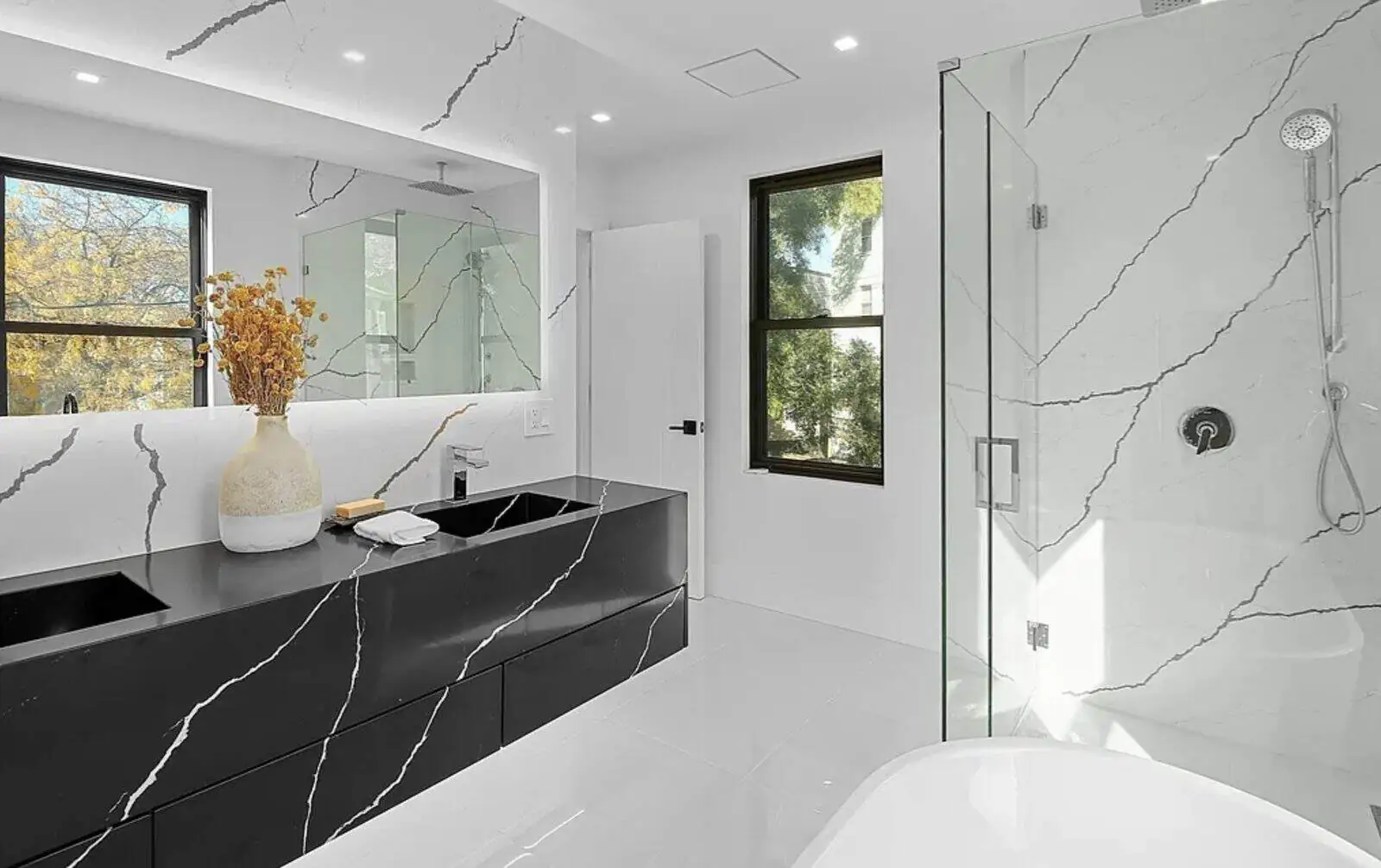 - 2 Modern bathroom with black marble vanity and white marble shower walls in Stoneham, MA by Pablo Marble and Granite