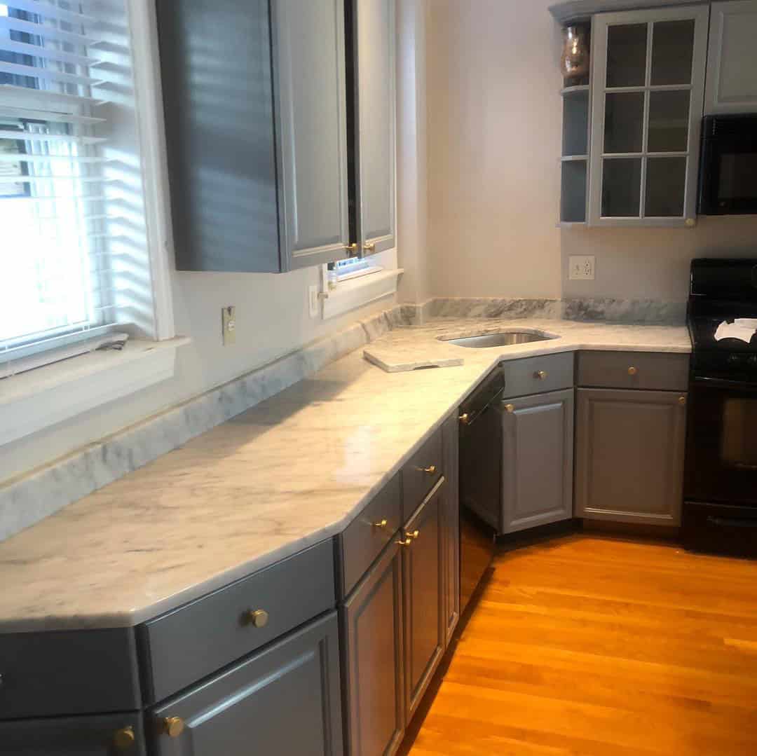 - 1 Marble countertop with undermount sink and grey cabinetry by Pablo Marble and Granite