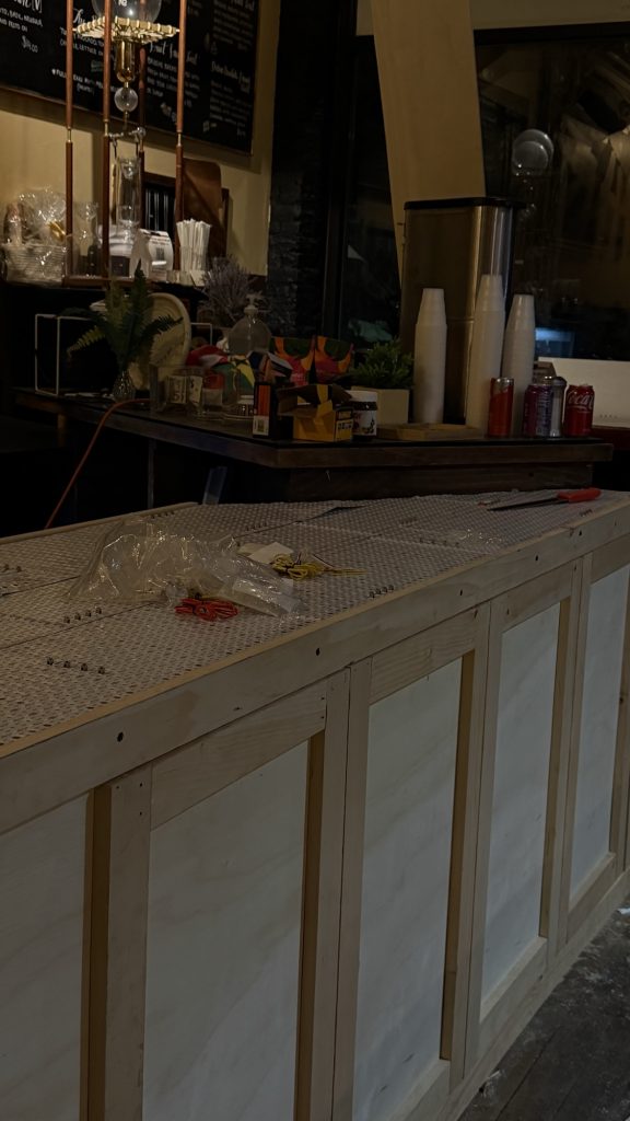- 5 Plywood counter base with flat LED light panel and wiring during install at Luxor Cafe
