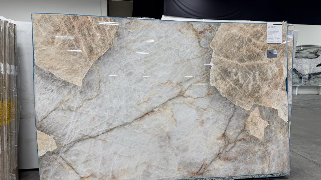 - 2 Patagonia quartzite slab on the showroom rack, tagged Patagonia Polished, showing finish and origin